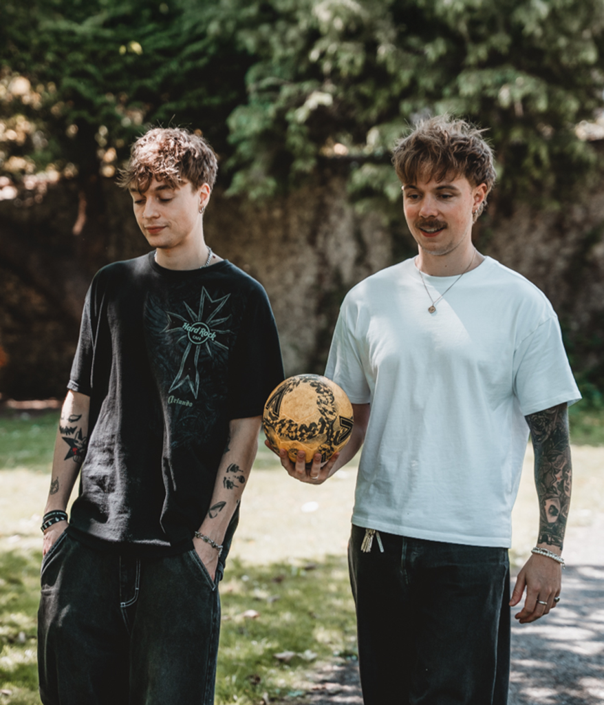 Two young men with football