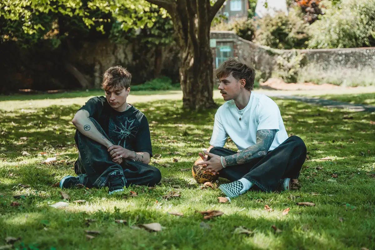 Men siiting on ground chatting